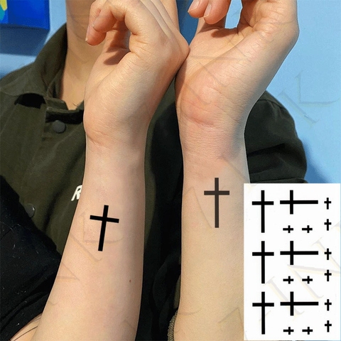 small cross tattoo on finger