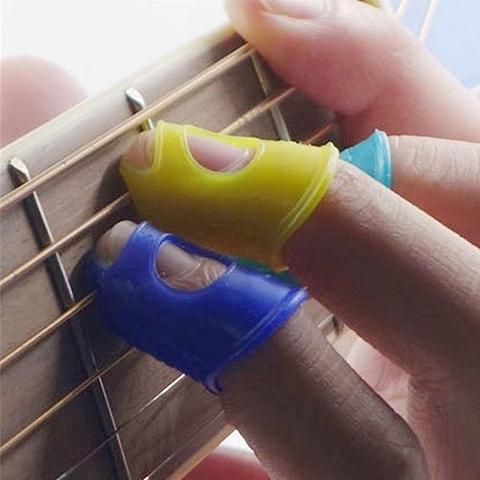4 unids/set Guitarra de silicona Protector para punta del dedo Gel dedo guardias Guitarra cuerdas Fingerguards pulgar uñas proteger la cubierta ► Foto 1/6
