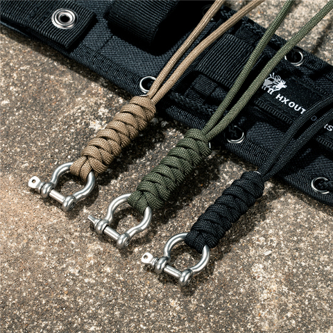 Estilo Aire Libre llavero con diseño de Paracord Lanyard hebilla de lazo D cuerda de paracaídas de alta resistencia llavero de Herramienta de supervivencia de emergencia de autodefensa ► Foto 1/6