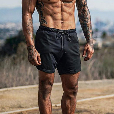 Verano de los hombres pantalones de secado rápido pantalones cortos de Color liso hombres playa Fitness Jogger de malla de Material ligero ► Foto 1/6